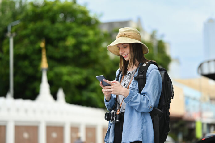 Happy caucasian female traveler with backpack on holiday vacatio